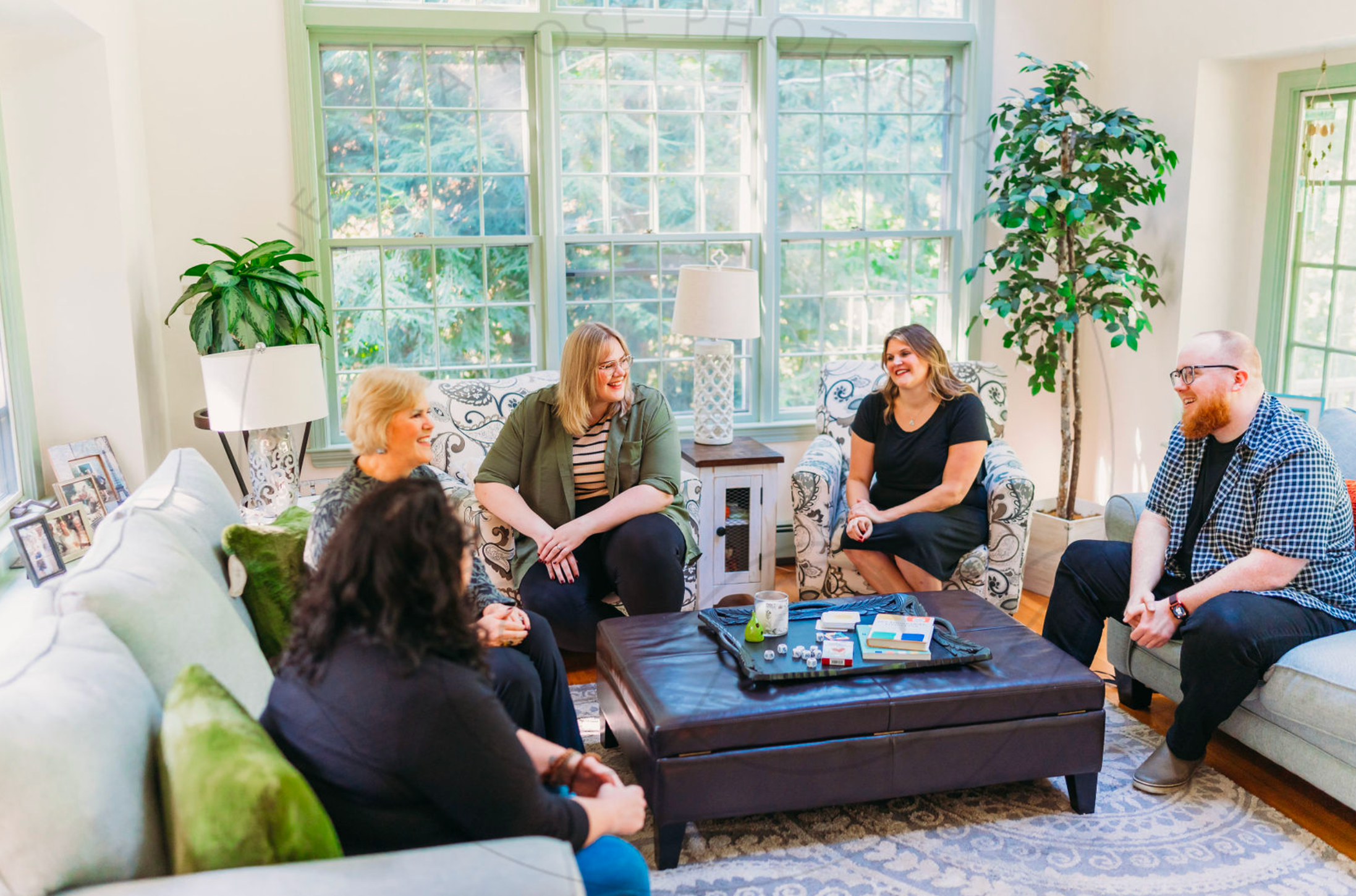 A candid shot of 3 women in a meeting with Ollie Taylor in a casual setting.